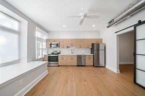 Philadelphia apartment for rent - a living room with a kitchen and a ceiling fan